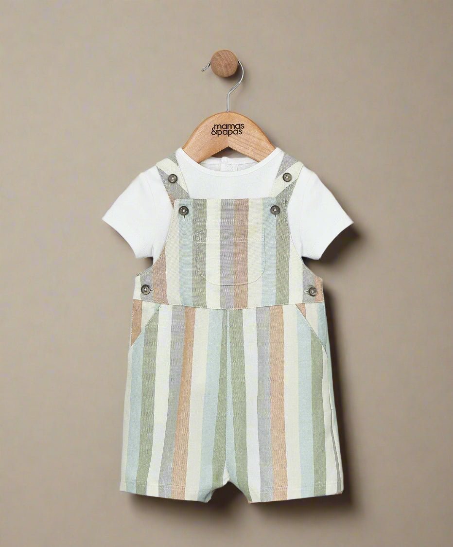 Striped dungaree romper over white T-shirt, vertical pastel stripes with button straps