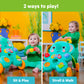 Child playing with turquoise elephant walker featuring number dial and ball slots