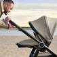 Ocarro stroller with gray canopy, black frame, and reclining seat, side view