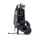 Ocarro stroller in upright folded view, gray canopy, black wheels and storage bag