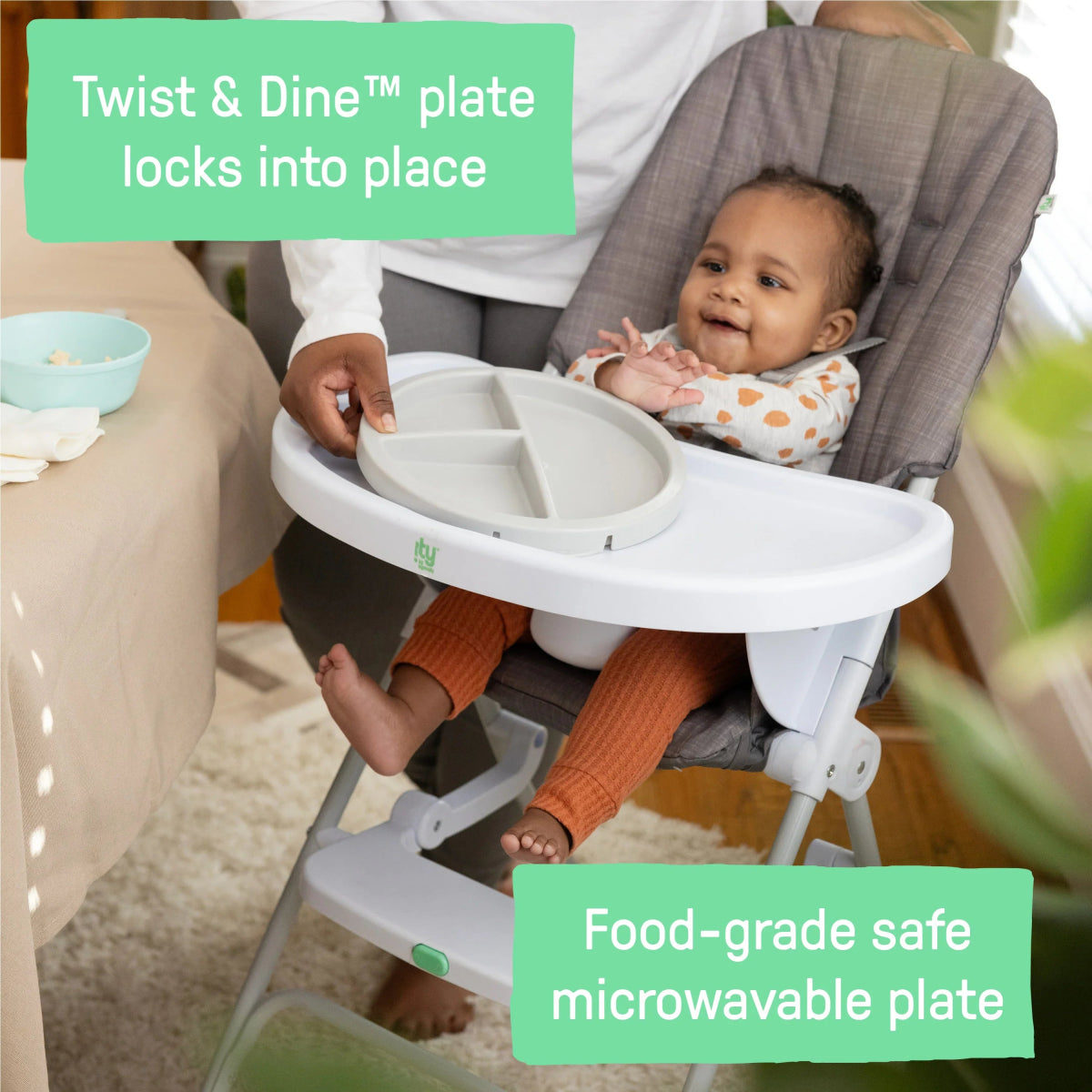 Gray high chair tray with inner divider plate and safety straps.