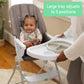 Gray high chair with adjustable tray in three-position support.