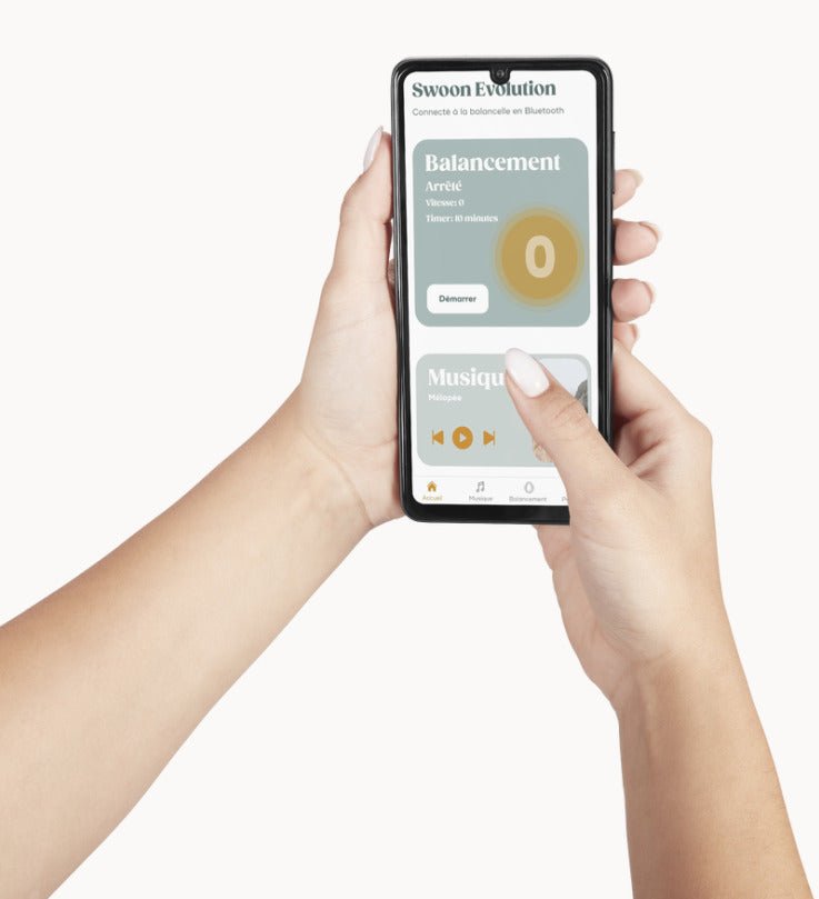 Smartphone displaying baby swing control app with balance and music settings.