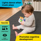 Baby holding handheld musical toy with colorful buttons and character face