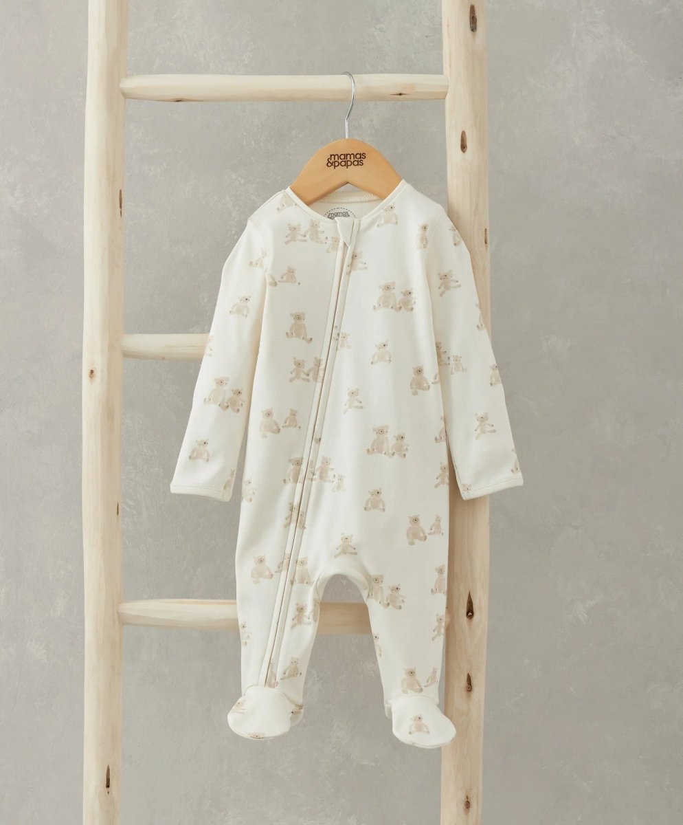 Cream teddy-print all-in-one footed romper with front zip and long sleeves
