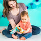 Toddler holding a colorful soft fabric book toy with animal pages