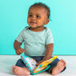 Toddler playing with teal and orange soft fabric book toy showing animal pages