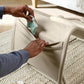 Baby rocker and bouncer fabric side panel being opened, light beige seat