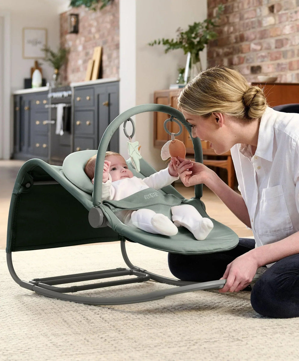 Baby rocker and bouncer with magnetic toy bar, mint seat, baby supported reclined