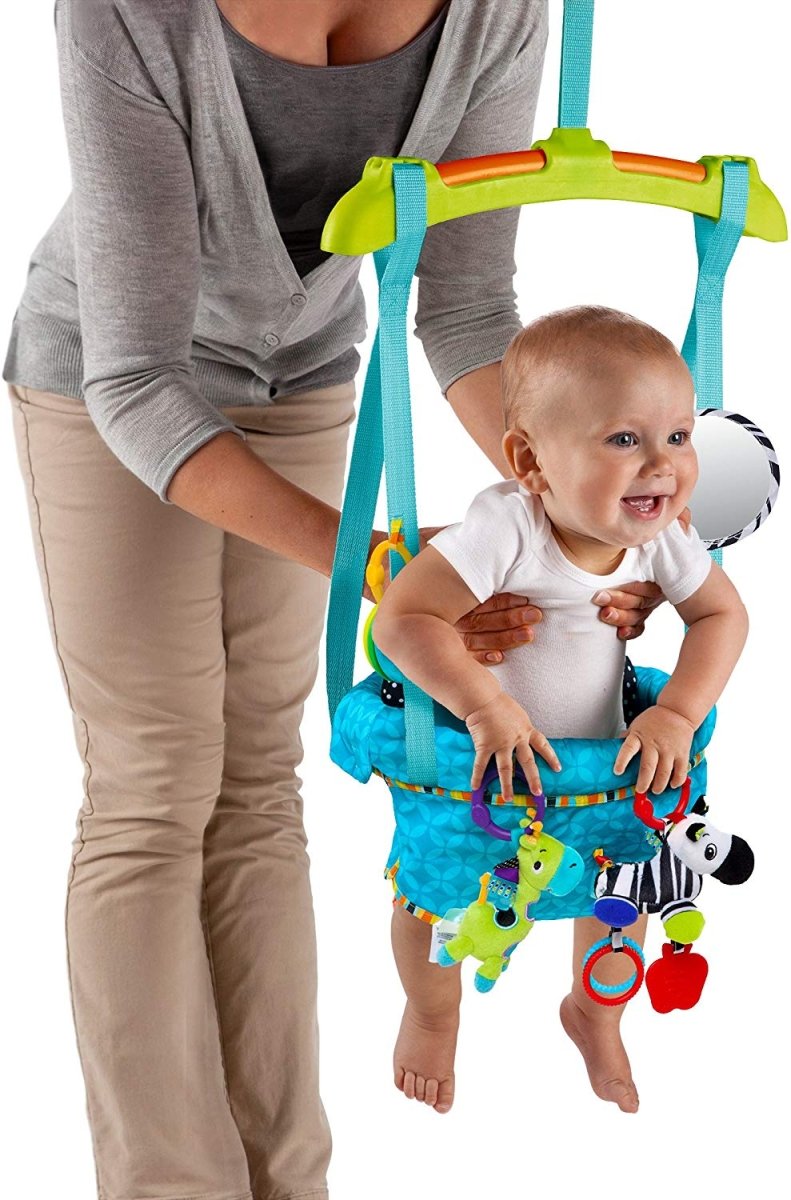 Baby wearing blue door jumper with hanging toys, zebra and green bird