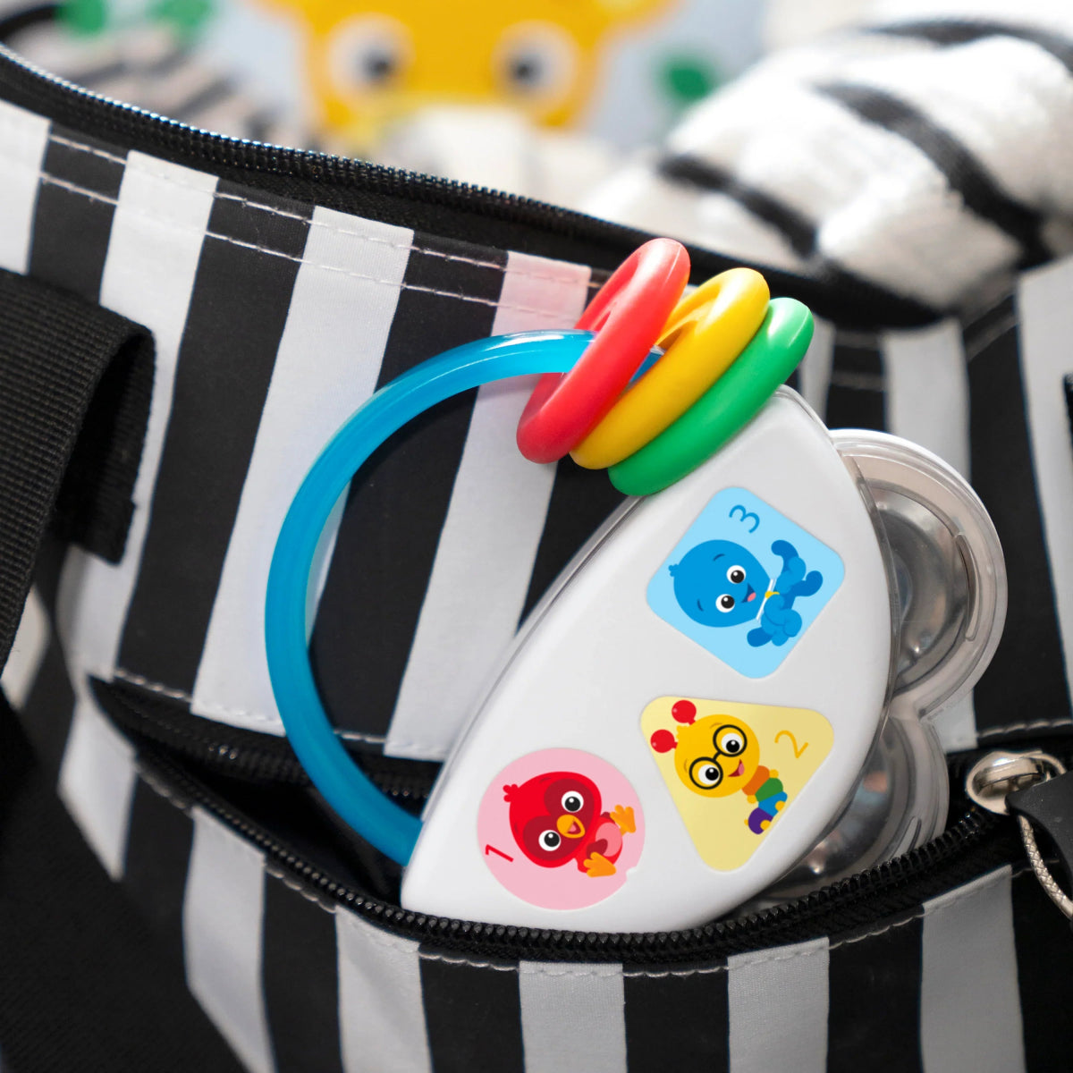Baby musical tambourine rattle with circular frame, animal faces, multicolor rings