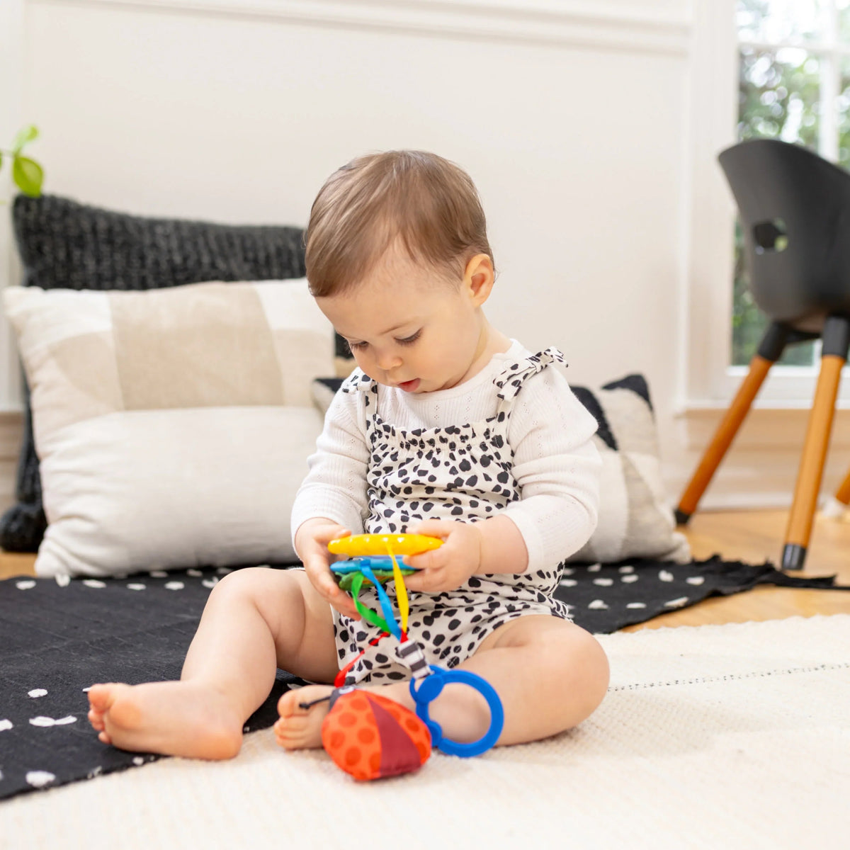Sensory play toy with hanging ring and soft fabric animal shapes on mat