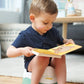 Children’s training potty with removable bowl in green and white, with child using it