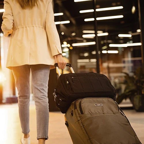 Black travel bag with front zip pocket and padded shoulder strap.