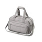 Light grey travel bag with top handle and front zip pocket, padded sides.