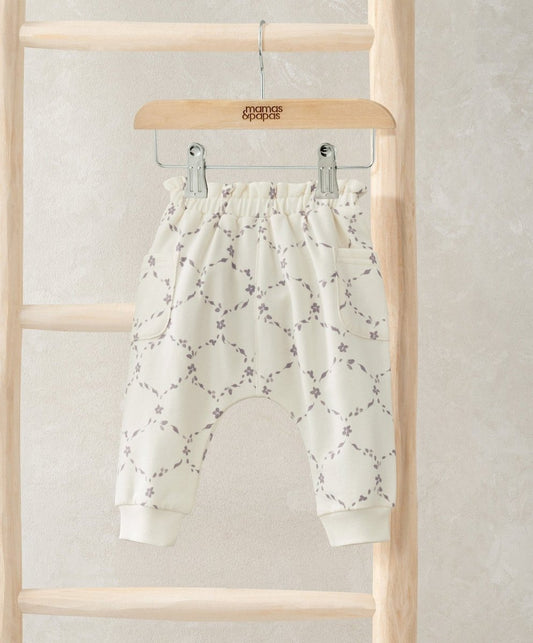 White trellis-print joggers with elastic cuffs and relaxed fit.