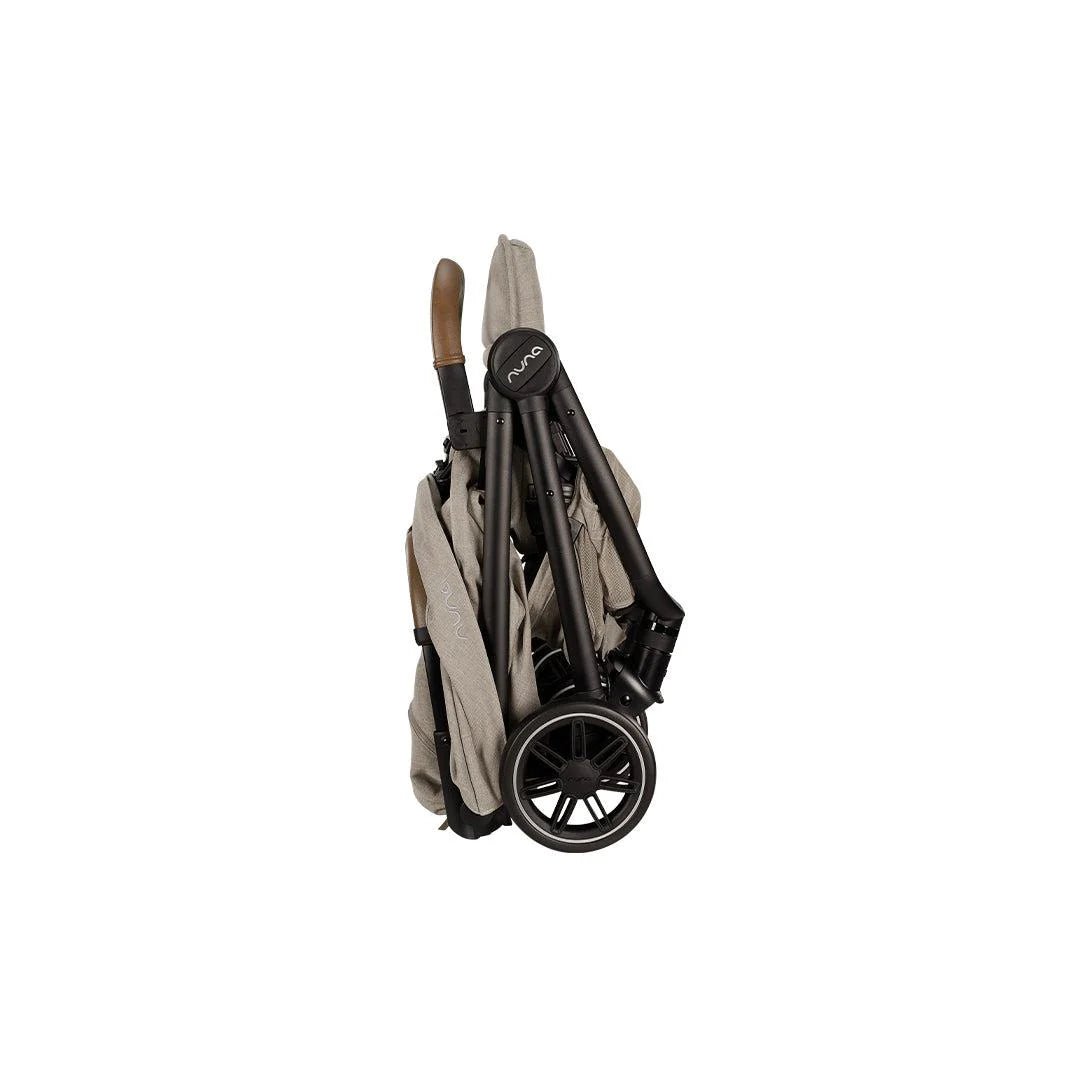 TRVL compact stroller in hazelwood folded side view with wheels and carrying strap