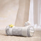 Cloud-print tummy time roll with yellow star toy, gray cylinder with white plush ends