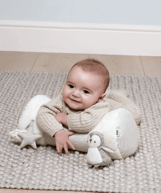 Tummy time roll pillow with plush animal toys, used for infant tummy time