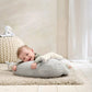 Elephant tummy time cushion rug in light gray with cream ear accents, with baby lying