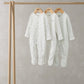 Baby sleepsuit set of 3: white printed, white solid, and light striped footed onesies