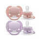 Pair of baby orthodontic pacifiers in coral and purple with vented shields
