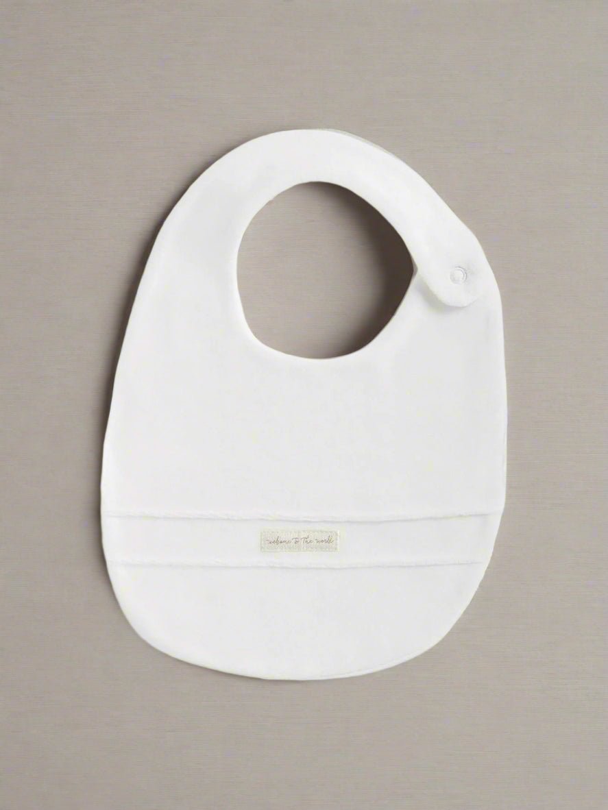 White velour baby bib with oval cutout and snap at neck