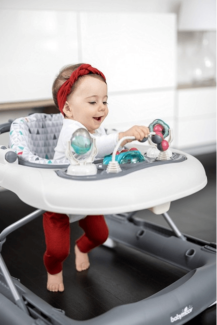 2-in-1 baby walker with beige tray, gray frame, child seated