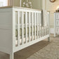 White cotbed with slatted sides and end panels