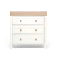 White nursery dresser changer with natural top and three drawer fronts, round wood knobs