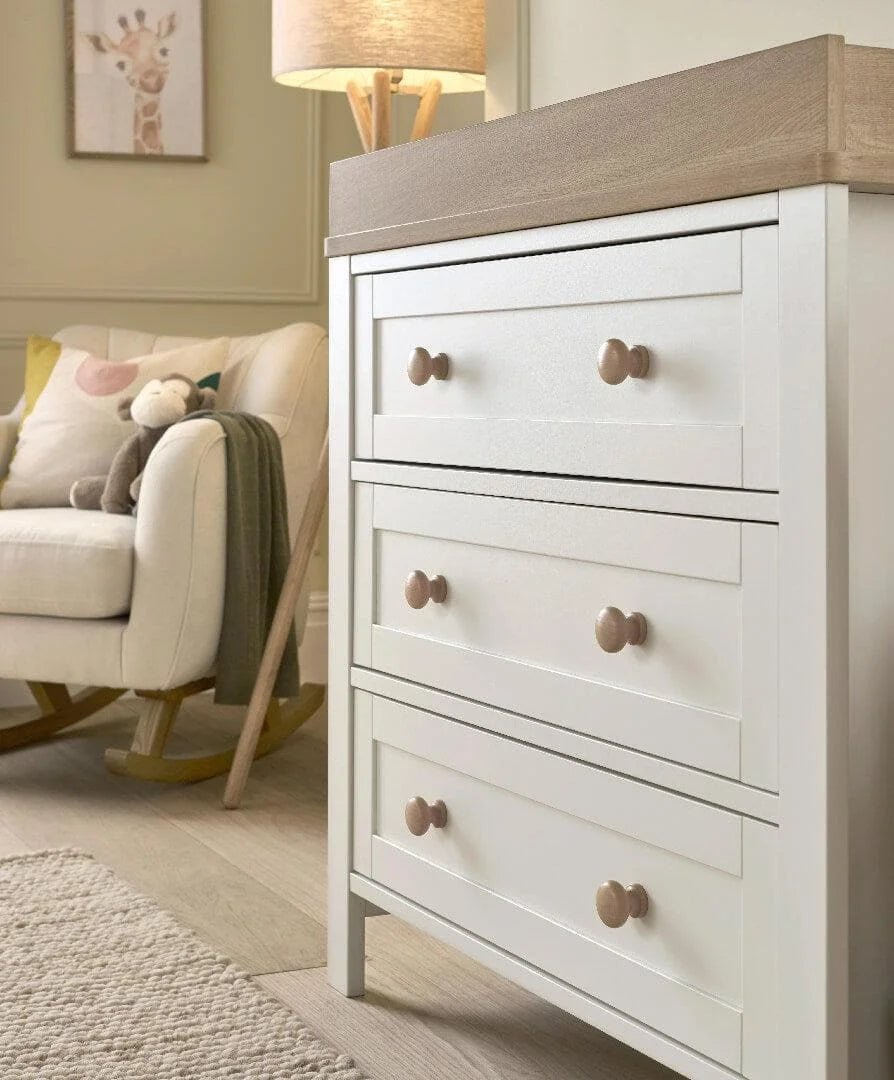 White nursery dresser changer with natural top and four drawers, round knobs