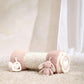 Pink plush bunny tummy time roll with textured body and side ring