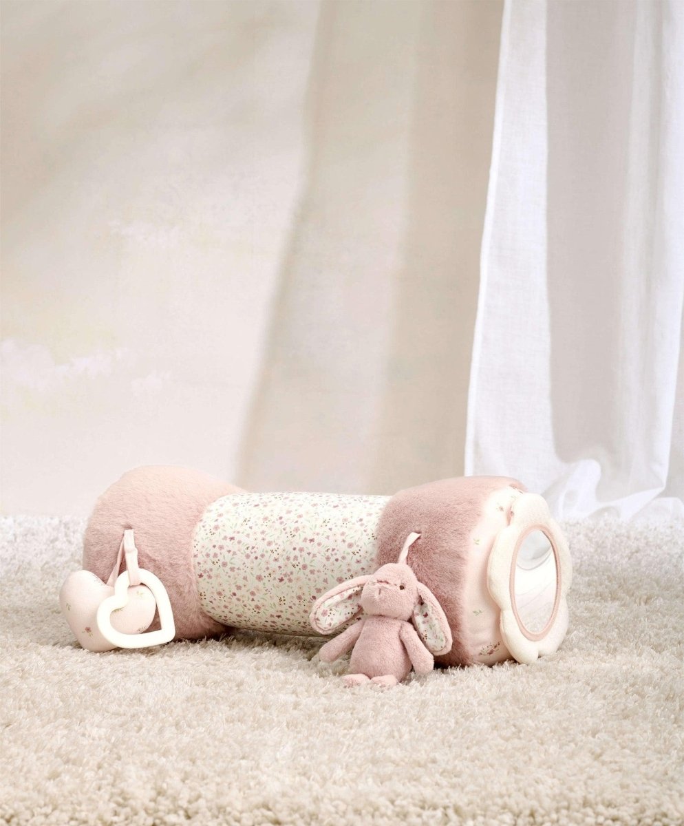 Pink plush bunny tummy time roll with textured body and side ring