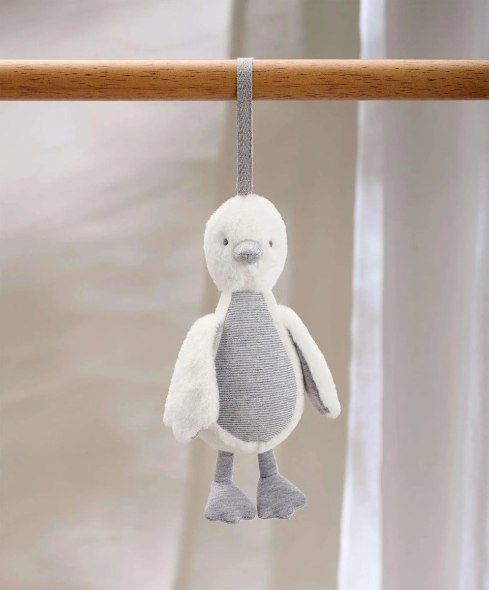 Grey plush duck chime travel toy hanging from a fabric strap