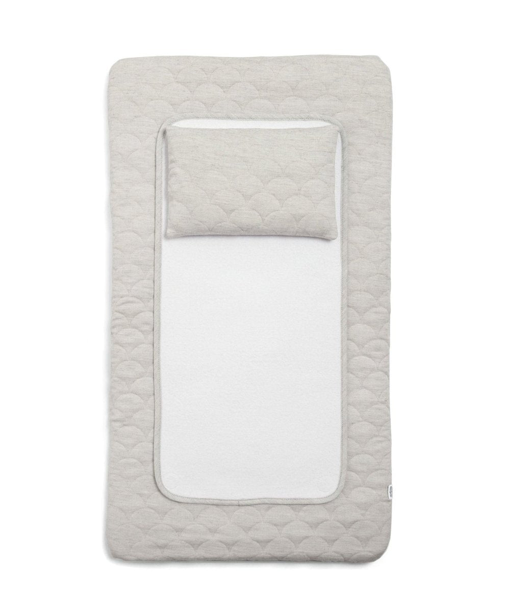 Grey quilted luxury changing mat with rounded inner opening and scalloped edge