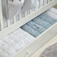 Cotbed quilt bedding: light blue and white quilt panels with stitched sheep motifs