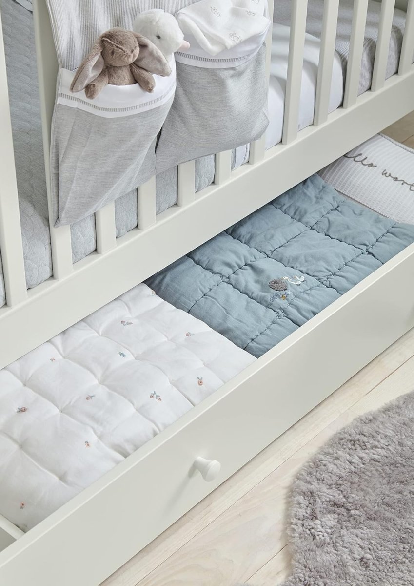 Cotbed quilt bedding: light blue and white quilt panels with stitched sheep motifs