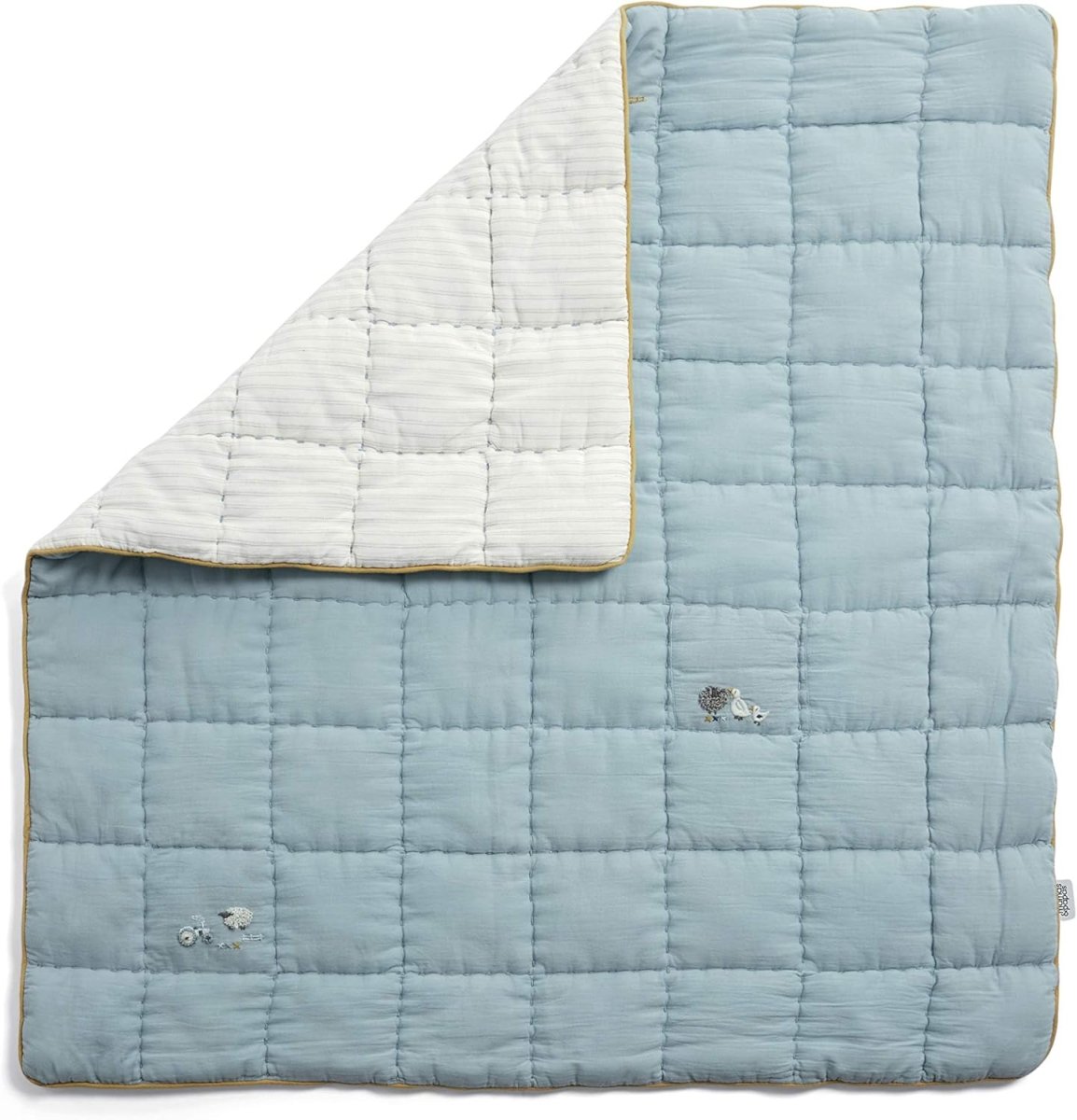 Blue cotbed quilt with white side, quilted squares and small embroidered sheep motifs