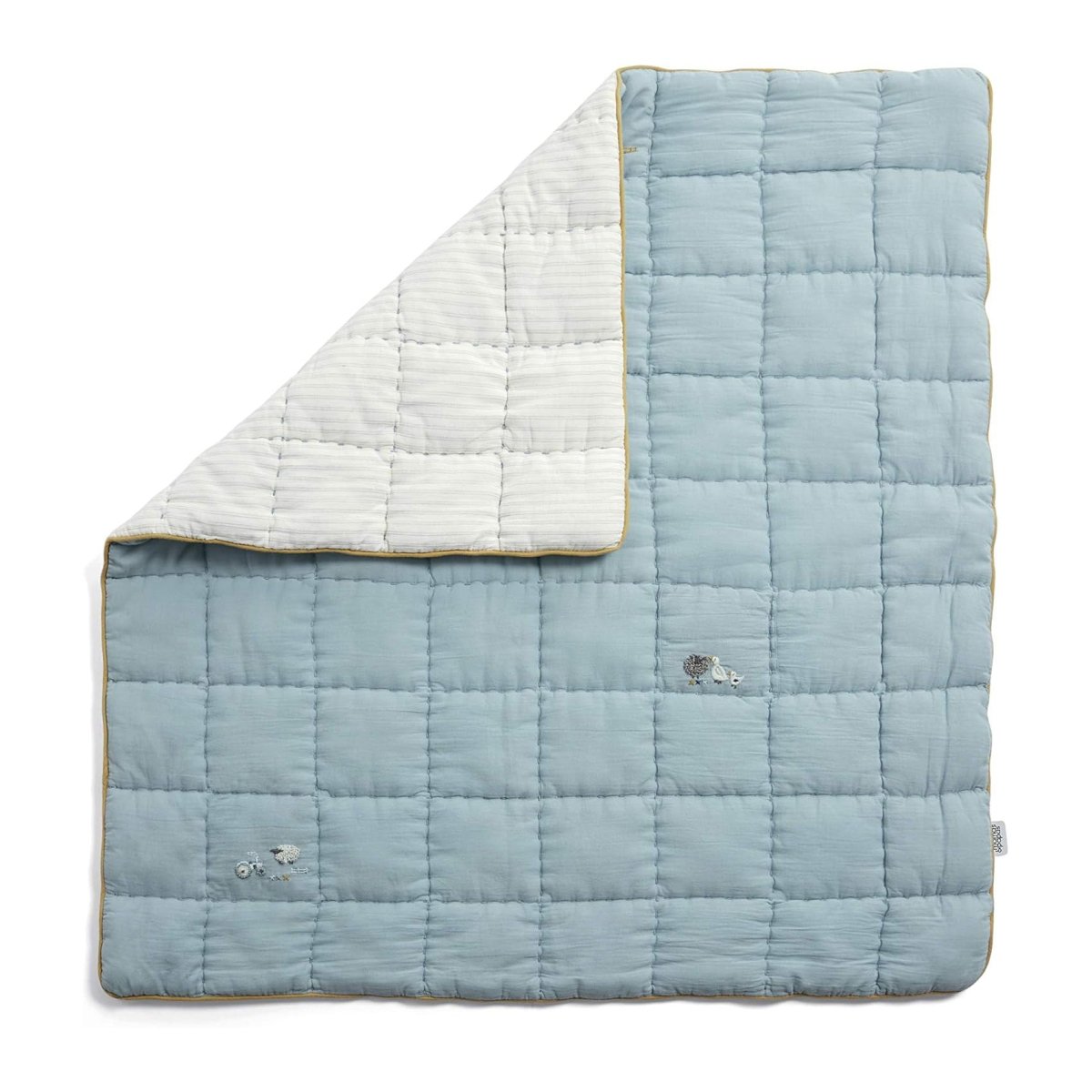 Cotbed quilt with light blue body, white reverse panel, quilted squares and sheep motifs