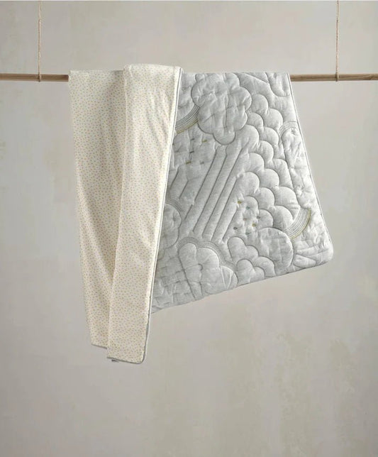 Cotbed quilt with raised cloud quilt pattern in light gray