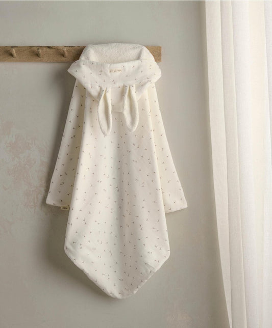 White hooded towel with small dot pattern and gathered neck, hanging