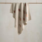 Knitted baby blanket with fruit print, light beige with peach and leaf motifs