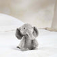 Small plush elephant toy, light gray with long trunk and floppy ears