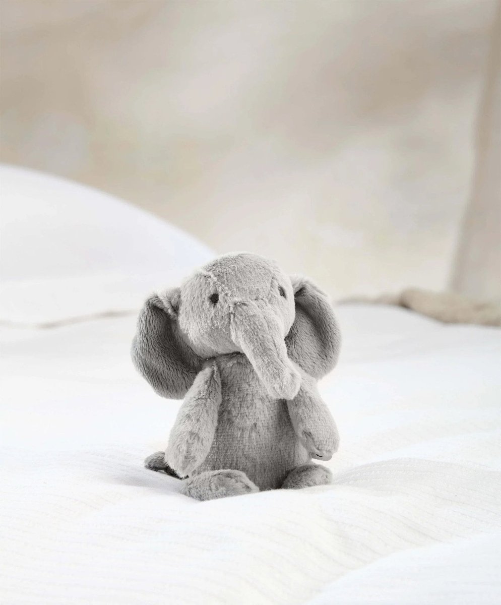 Small plush elephant toy, light gray sitting with trunk curled under chin
