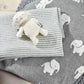Beige lamb beanie hat with striped knit and attached plush lamb on gray elephant fabric