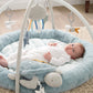 Blue round baby play mat with hanging sea-themed mobile and star-shaped toy