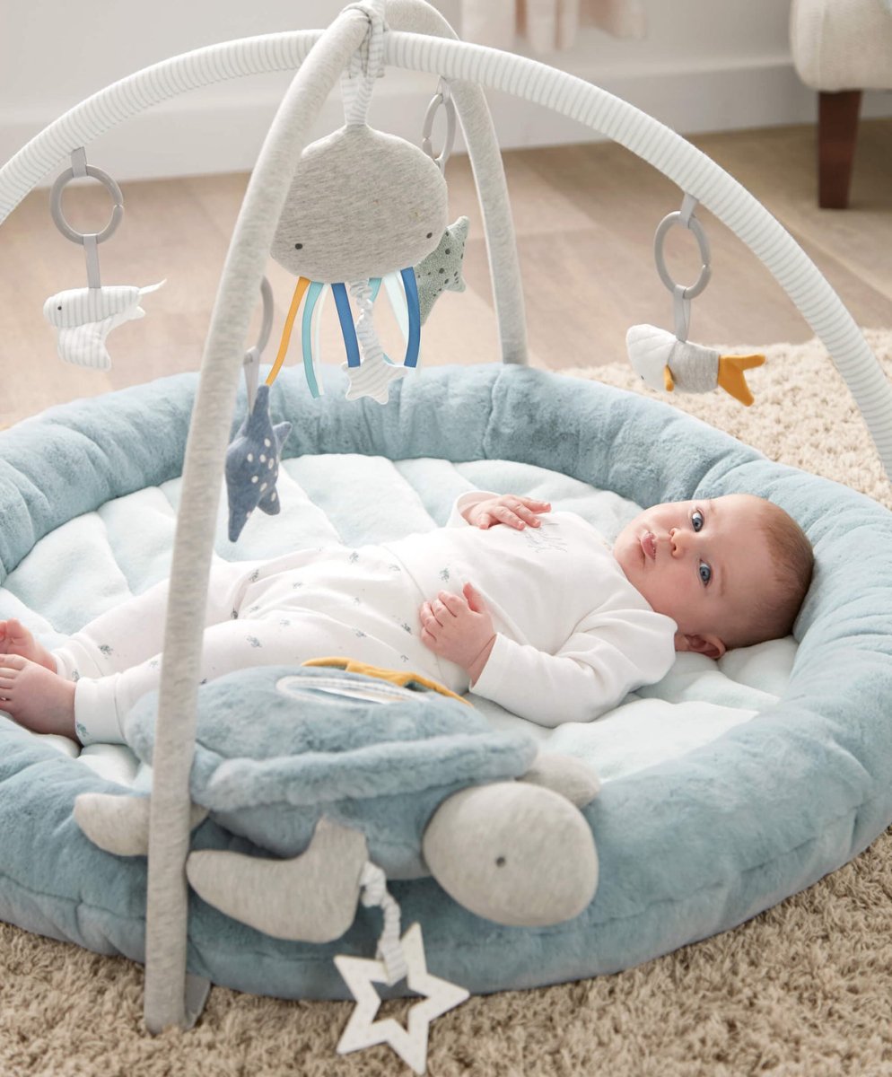 Blue round baby play mat with hanging sea-themed mobile and star-shaped toy