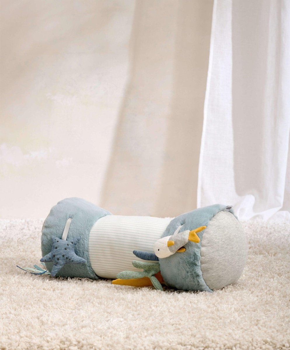 Blue ocean-themed tummy time roll with plush fish and sea creatures, curved bolsters