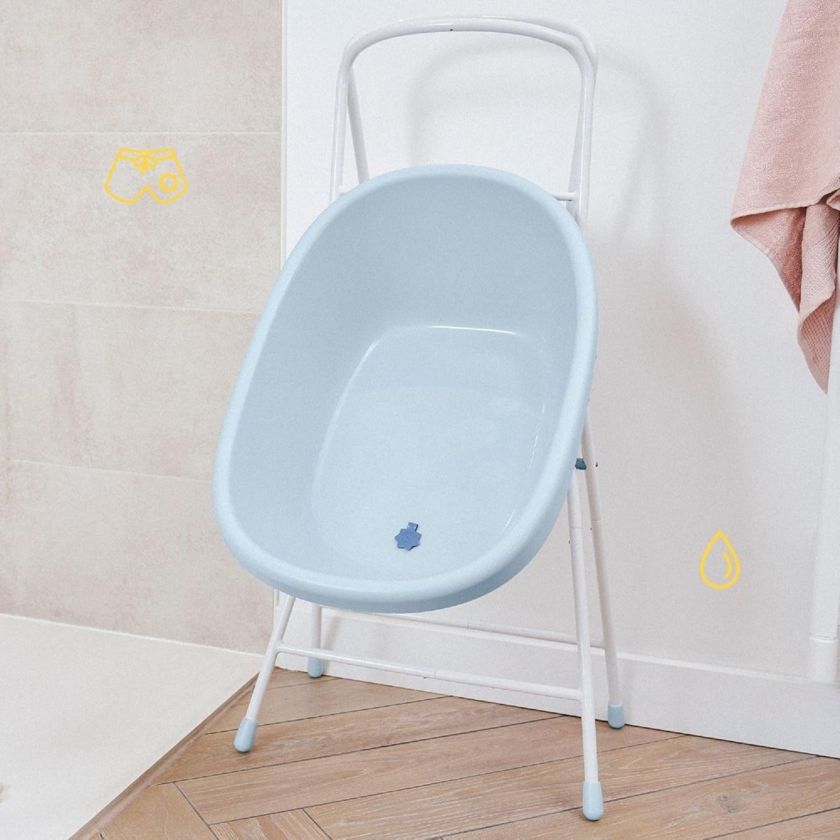 Light blue baby bath tub on white three-leg stand