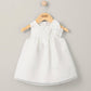 White organza bow dress on hanger, sleeveless with bow collar and gathered waist